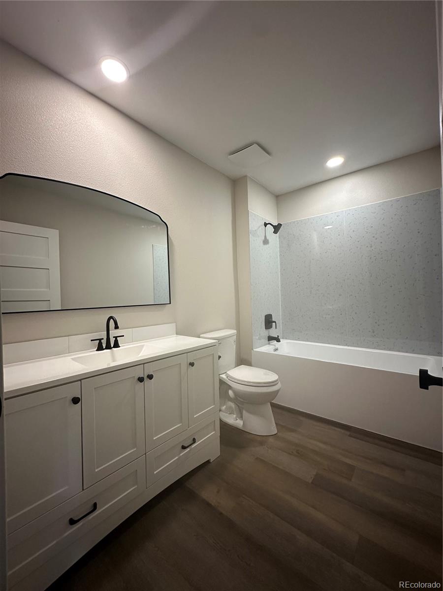 215 6th Street Hugo, CO 80821 - Photo 16 of 28 a bathroom with a double vanity sink and a mirror