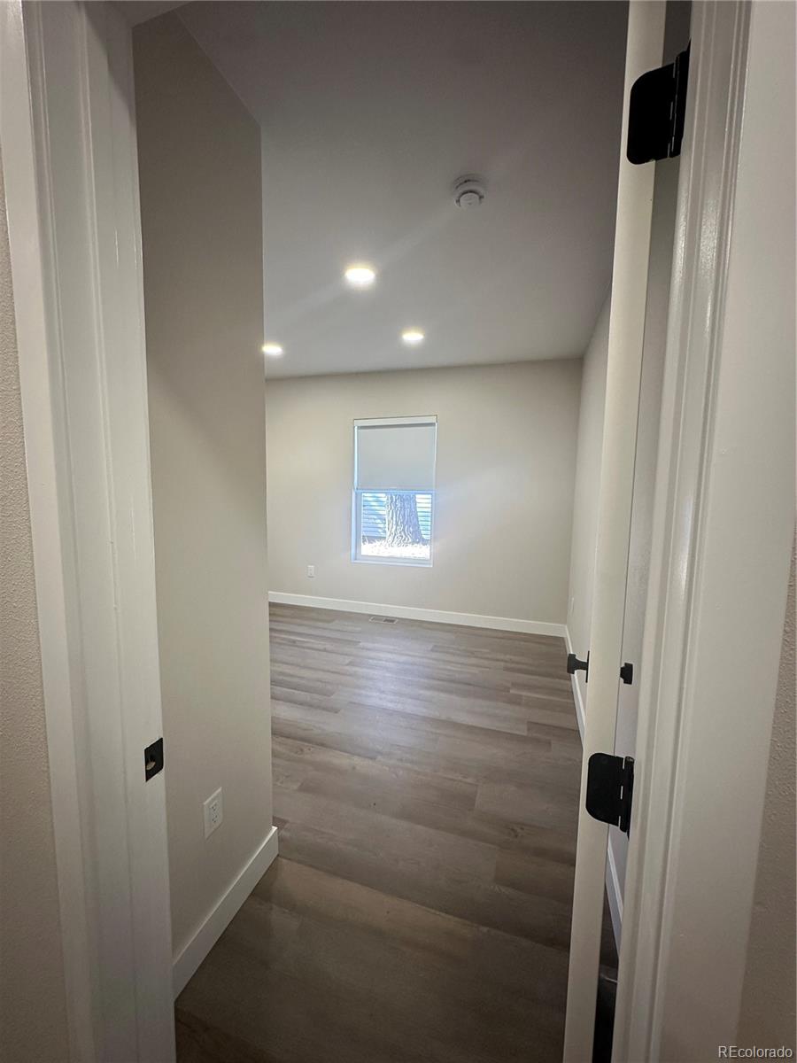 215 6th Street Hugo, CO 80821 - Photo 19 of 28 a view of hallway with stairs and wooden floor