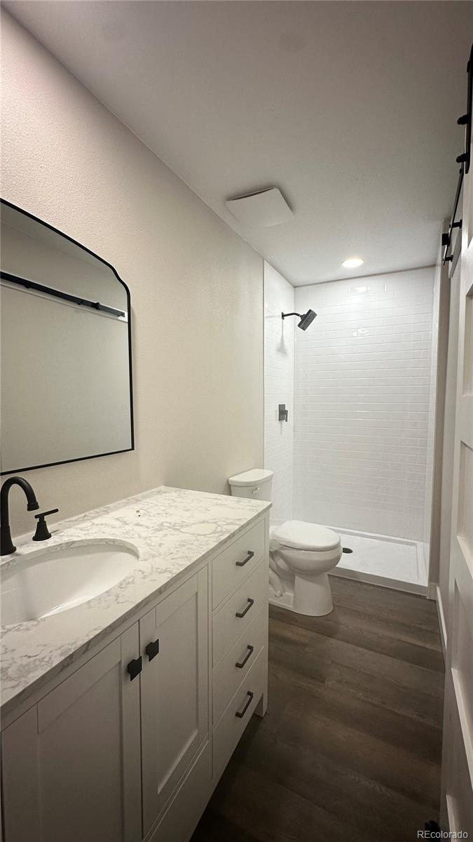215 6th Street Hugo, CO 80821 - Photo 21 of 28 a bathroom with a granite countertop sink toilet and shower