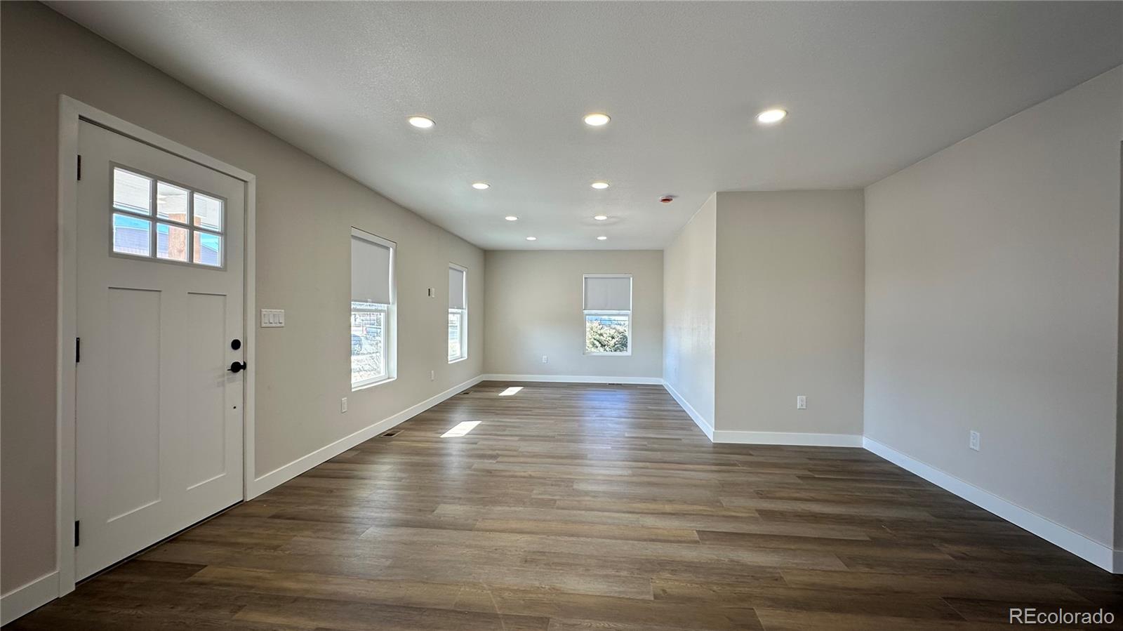 215 6th Street Hugo, CO 80821 - Photo 6 of 28 a view of an empty room with wooden floor and a window