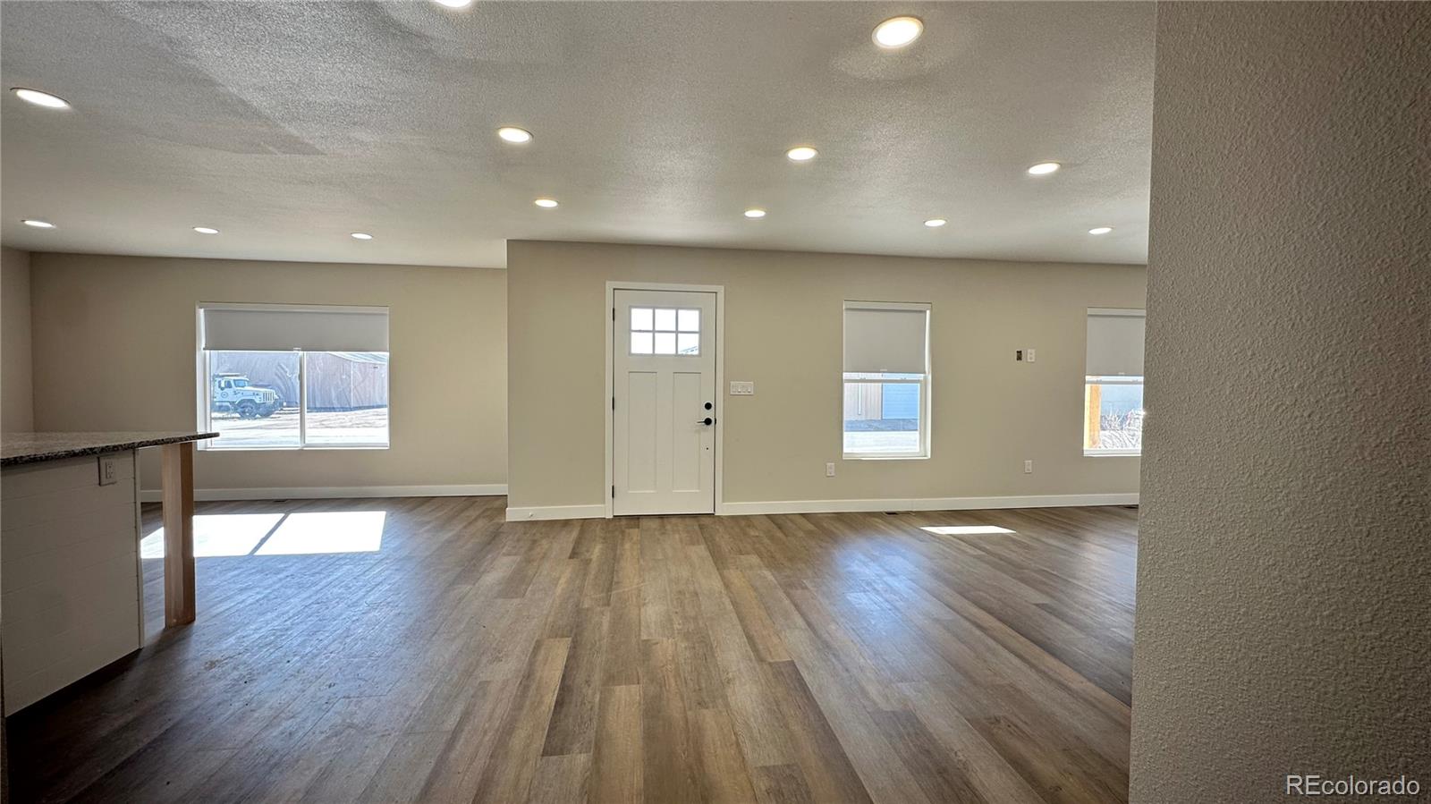 215 6th Street Hugo, CO 80821 - Photo 7 of 28 a view of an empty room with wooden floor and a window