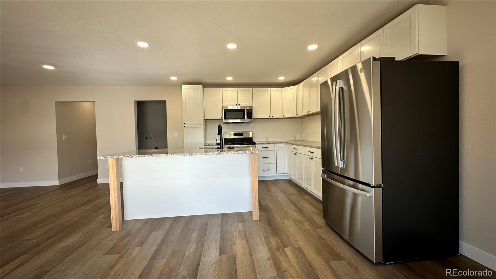215 6th Street Hugo, CO 80821 - Photo 9 of 28 a kitchen with stainless steel appliances a refrigerator and a stove top oven