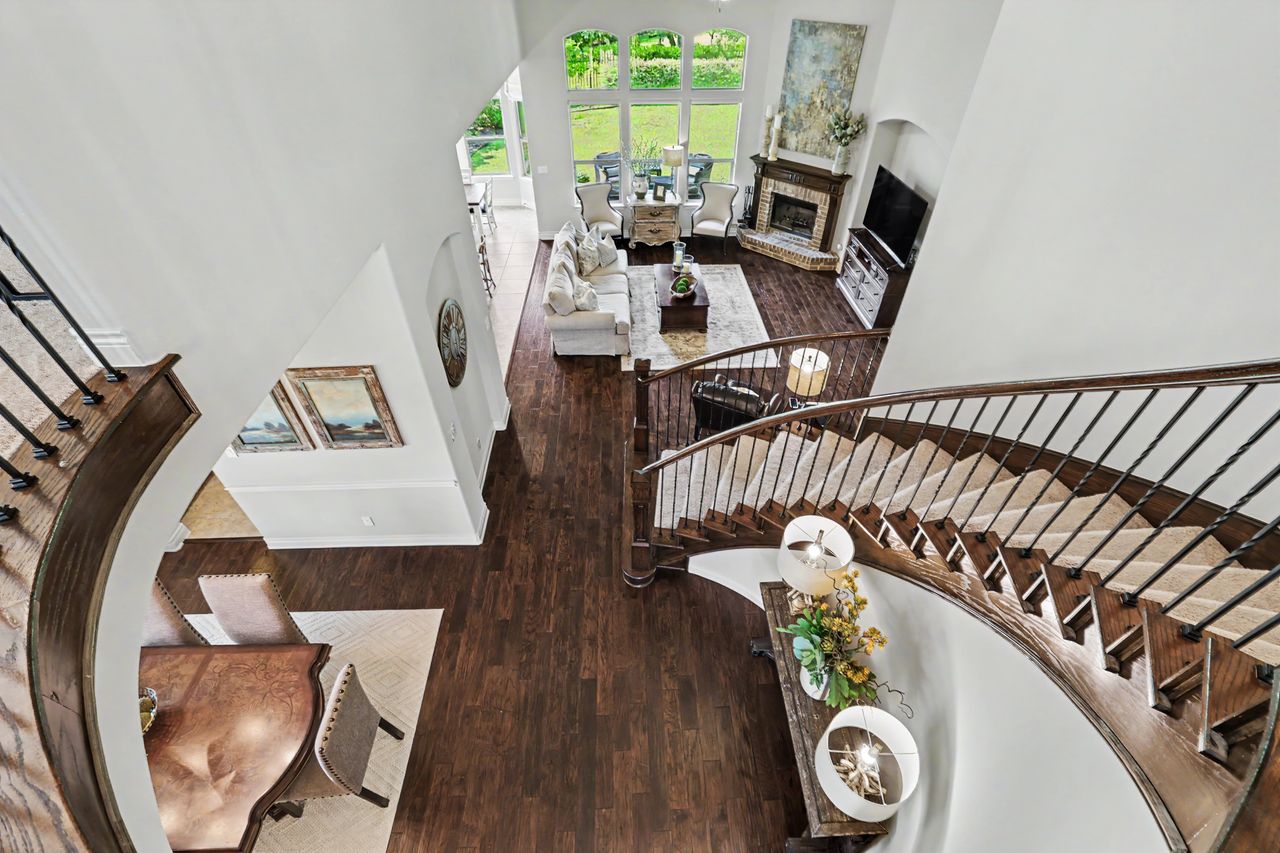 809 Prairie Dunes Drive Georgetown, TX 78628 - Photo 34 of 40 Elegant hardwood flooring flows throughout this open concept living space, anchored by a grand staircase.