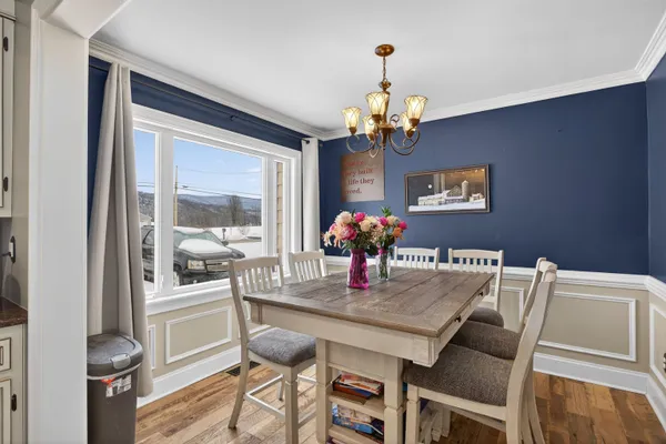 a view of a dining room with furniture and chandelier