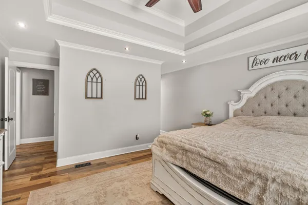 a bedroom with a bed and painting on the wall