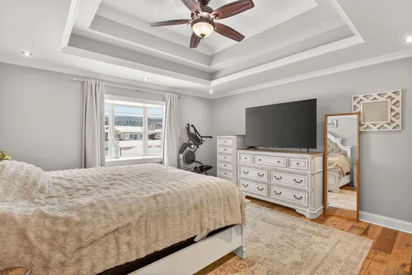a bedroom with a bed flat screen tv and dresser