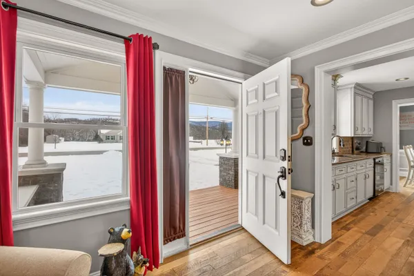 a view of a kitchen with an entryway and wooden floor