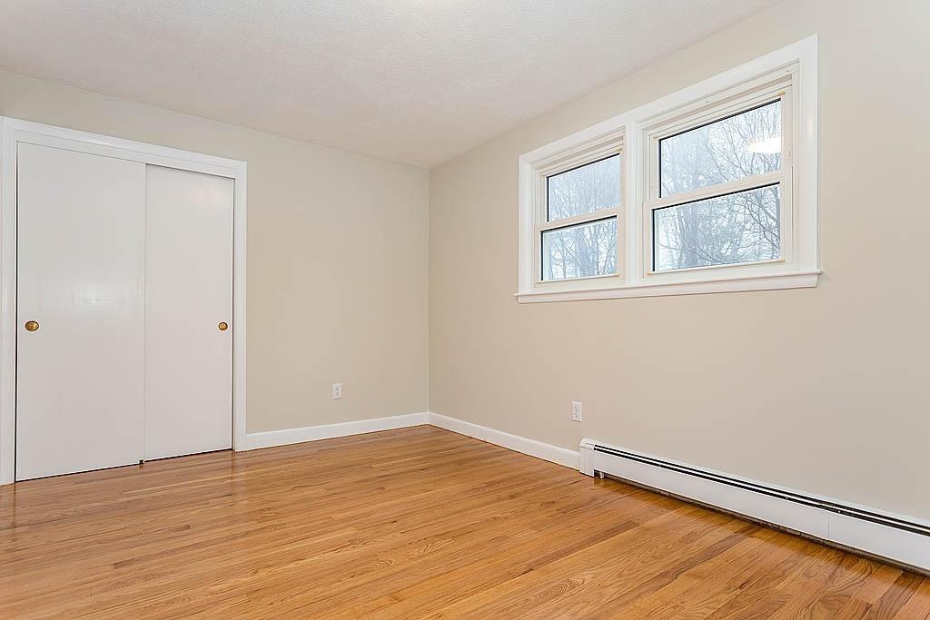 25 Garland Road Chelmsford, MA 01824 - Photo 13 of 25 a view of an empty room with wooden floor and a window