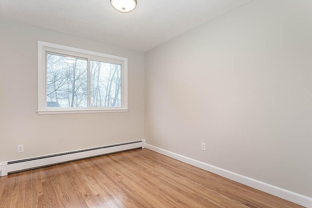 25 Garland Road Chelmsford, MA 01824 - Photo 15 of 25 an empty room with wooden floor and windows