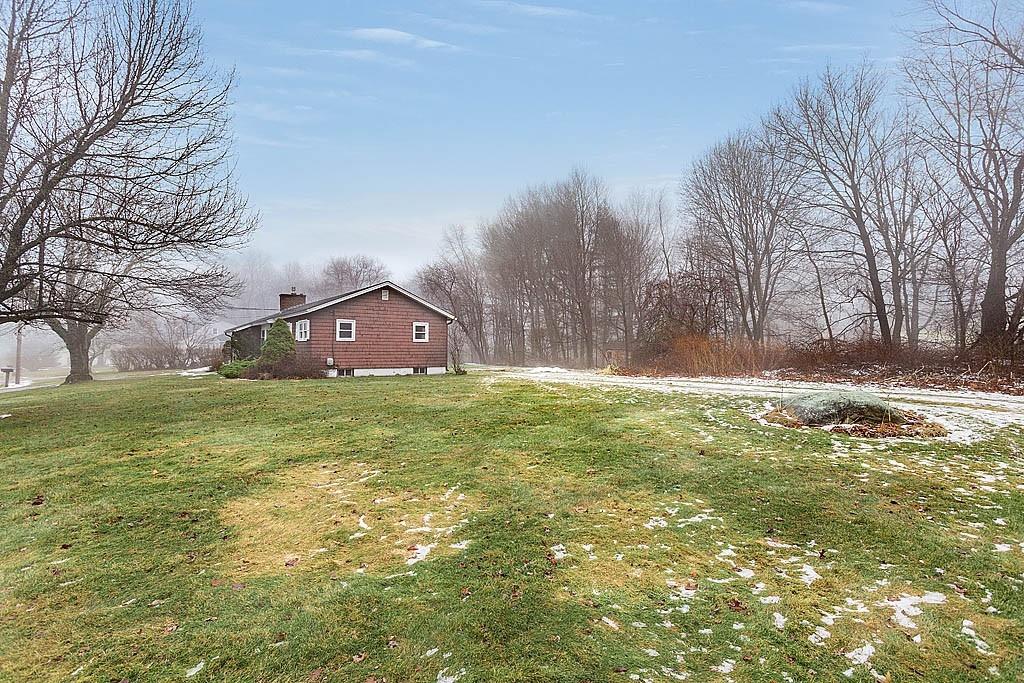 25 Garland Road Chelmsford, MA 01824 - Photo 23 of 25 a view of a yard with a house in the background