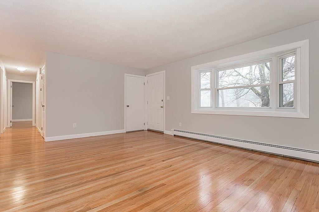 25 Garland Road Chelmsford, MA 01824 - Photo 3 of 25 a view of an empty room with wooden floor and a window