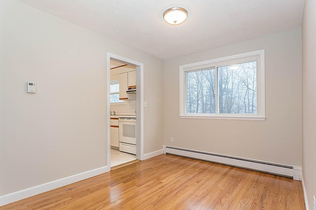 25 Garland Road Chelmsford, MA 01824 - Photo 4 of 25 an empty room with wooden floor and windows