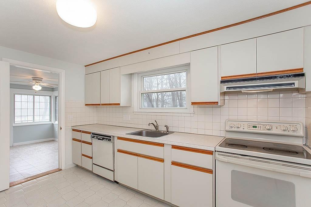 25 Garland Road Chelmsford, MA 01824 - Photo 5 of 25 a kitchen with cabinets appliances a sink and a window