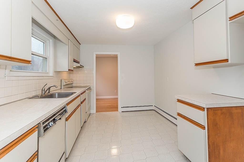 25 Garland Road Chelmsford, MA 01824 - Photo 6 of 25 a kitchen with a sink a stove and a refrigerator
