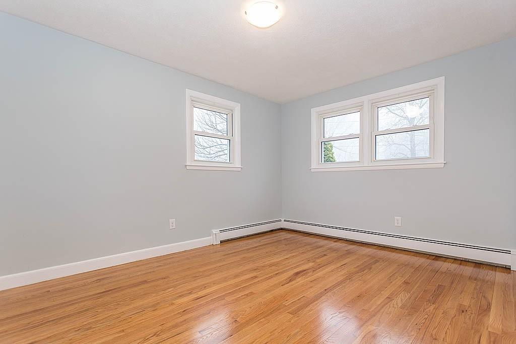 25 Garland Road Chelmsford, MA 01824 - Photo 10 of 25 wooden floor in an empty room with a window
