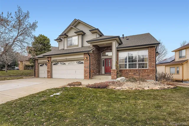 a front view of a house with a yard and garage