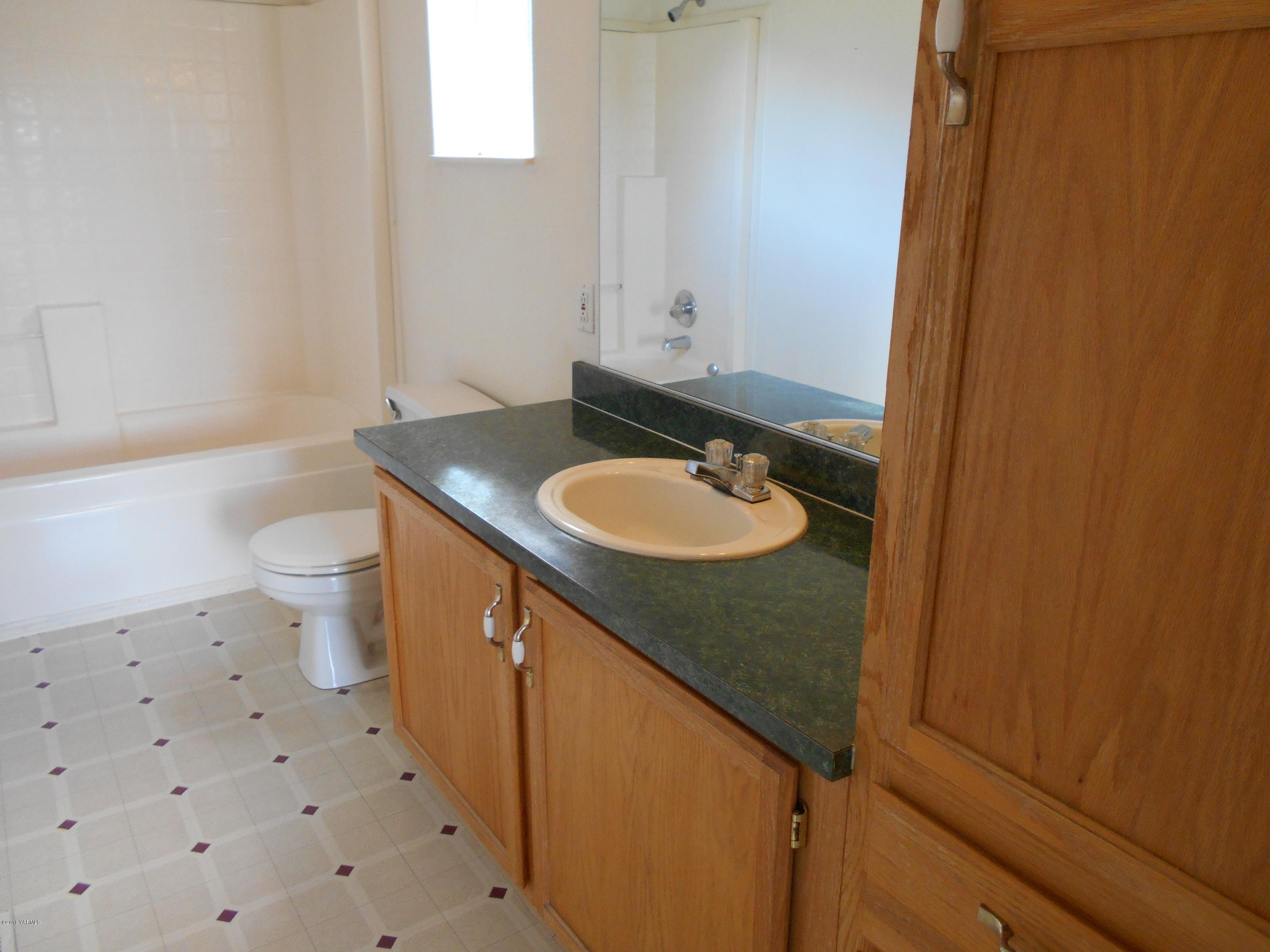 4051 Wenas Road South Selah, WA 98942 - Photo 12 of 21 a bathroom with a granite countertop sink toilet and a mirror