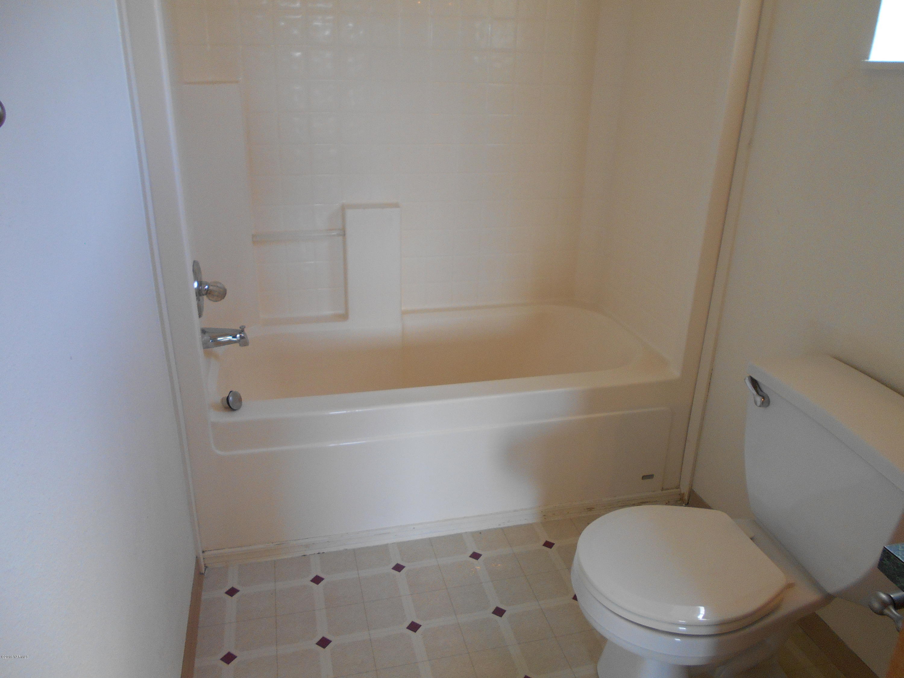 4051 Wenas Road South Selah, WA 98942 - Photo 13 of 21 a white toilet sitting next to a bath tub