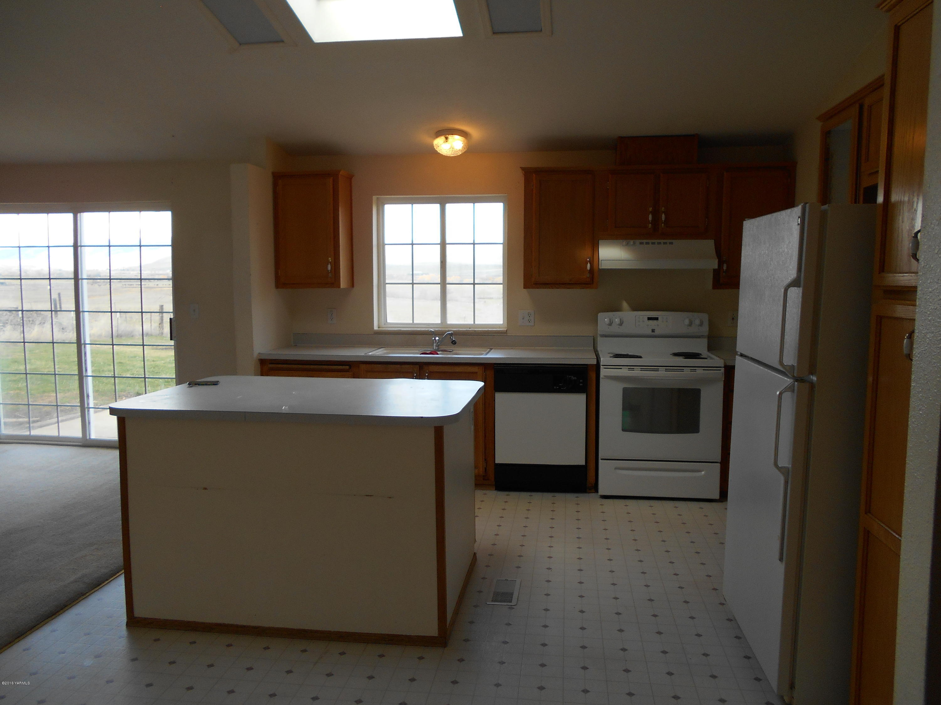 4051 Wenas Road South Selah, WA 98942 - Photo 7 of 21 a kitchen with stainless steel appliances a refrigerator a sink a stove and cabinets