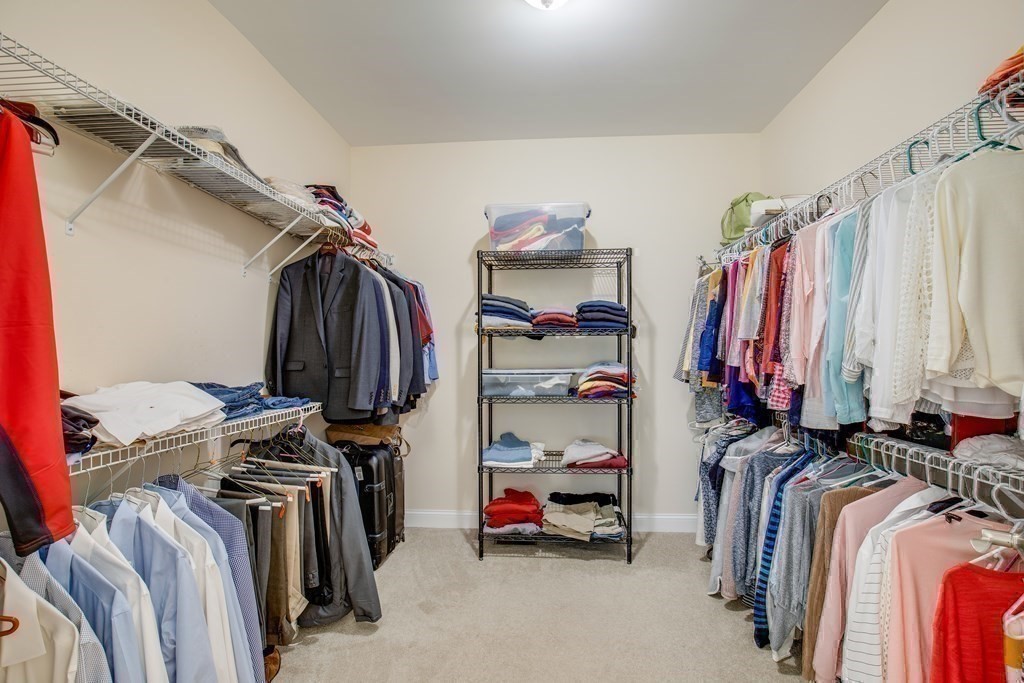 9 Riverview Heights, Unit 48 Amesbury, MA 01913 - Photo 16 of 37 a view of walk in closet with clothes and shoes