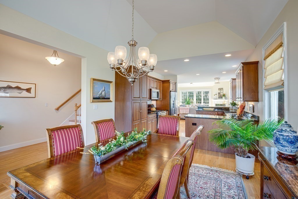 9 Riverview Heights, Unit 48 Amesbury, MA 01913 - Photo 10 of 37 a view of a dining room with furniture a chandelier and wooden floor