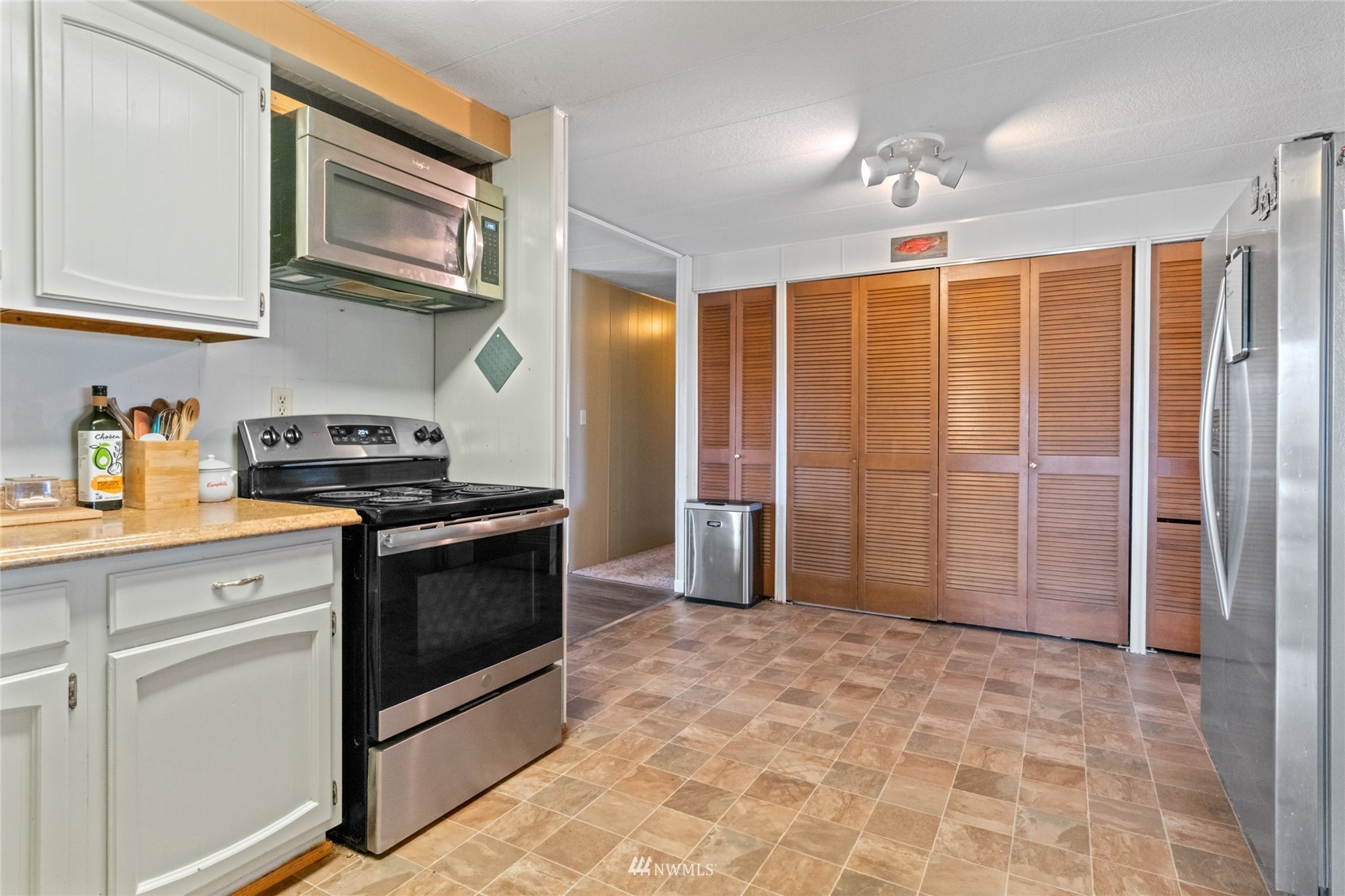 1 George Road Omak, WA 98841 - Photo 15 of 38 a kitchen with stainless steel appliances granite countertop a refrigerator and a stove top oven