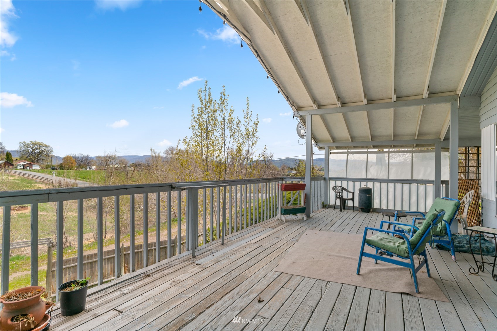 1 George Road Omak, WA 98841 - Photo 7 of 38 a view of a balcony with chairs and wooden floor