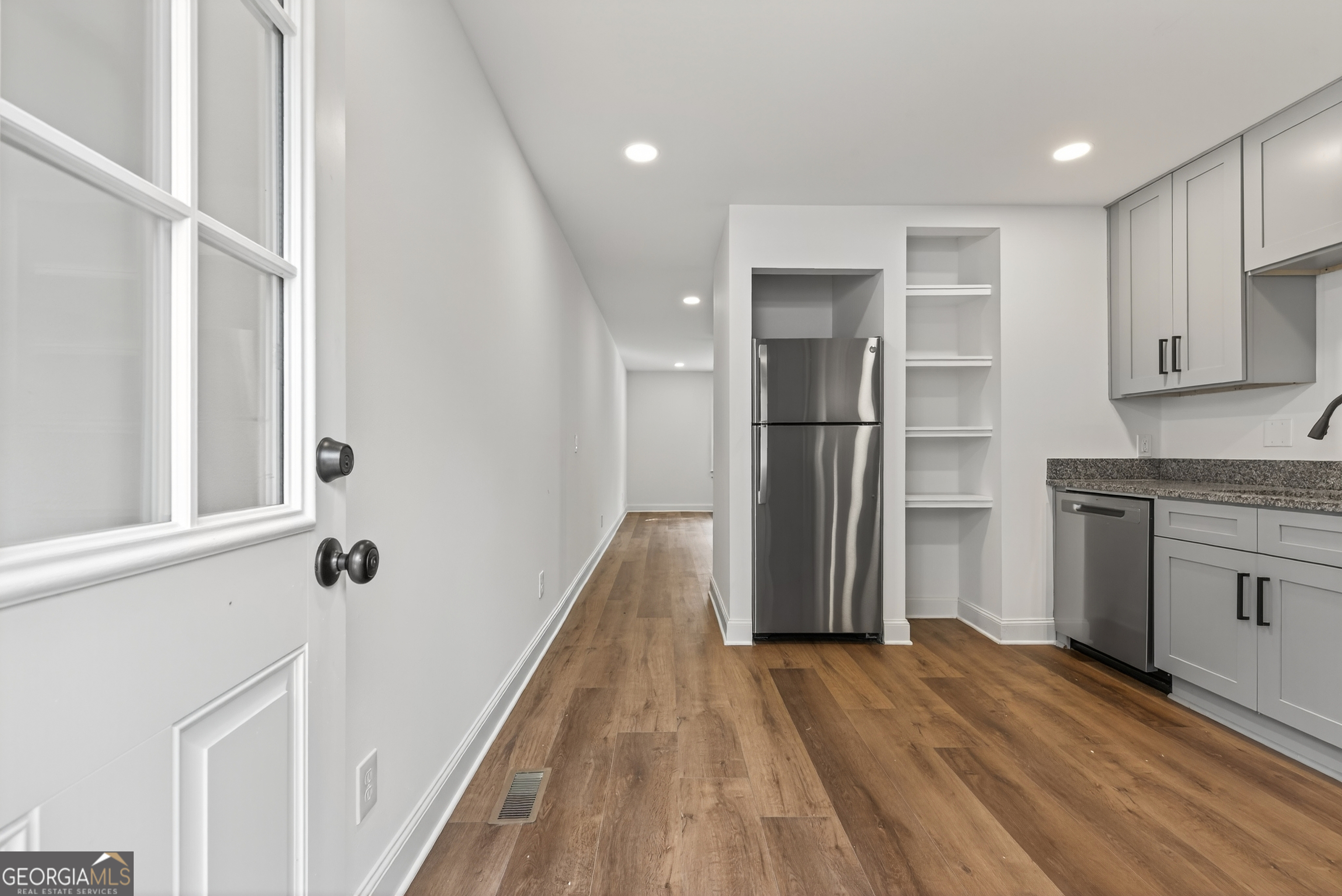 475 Vine Street, Unit B Madison, GA 30650 - Photo 11 of 23 a view of a kitchen with a sink and refrigerator