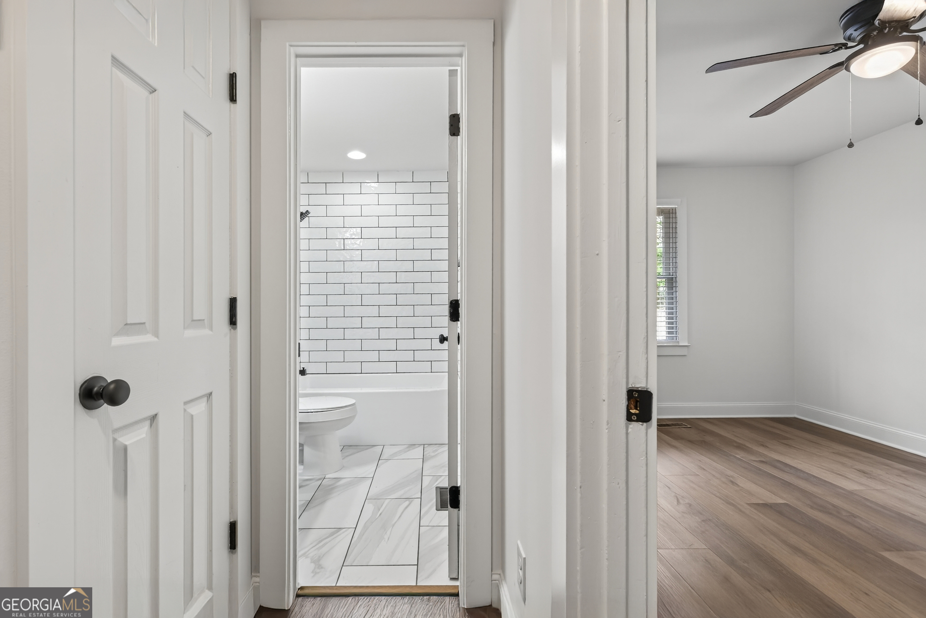 475 Vine Street, Unit B Madison, GA 30650 - Photo 14 of 23 a view of a bathroom from a hallway