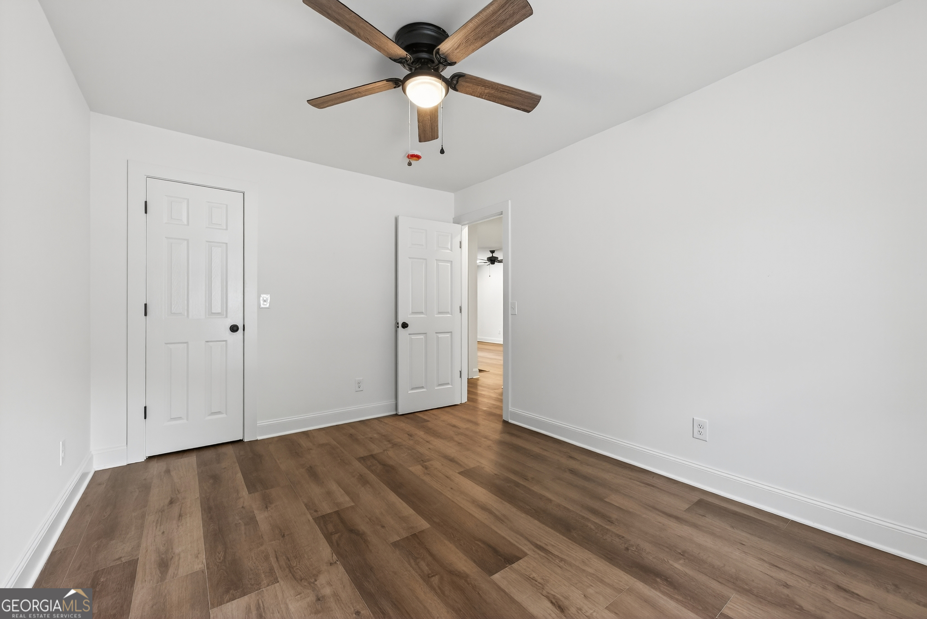 475 Vine Street, Unit B Madison, GA 30650 - Photo 17 of 23 wooden floor in an empty room