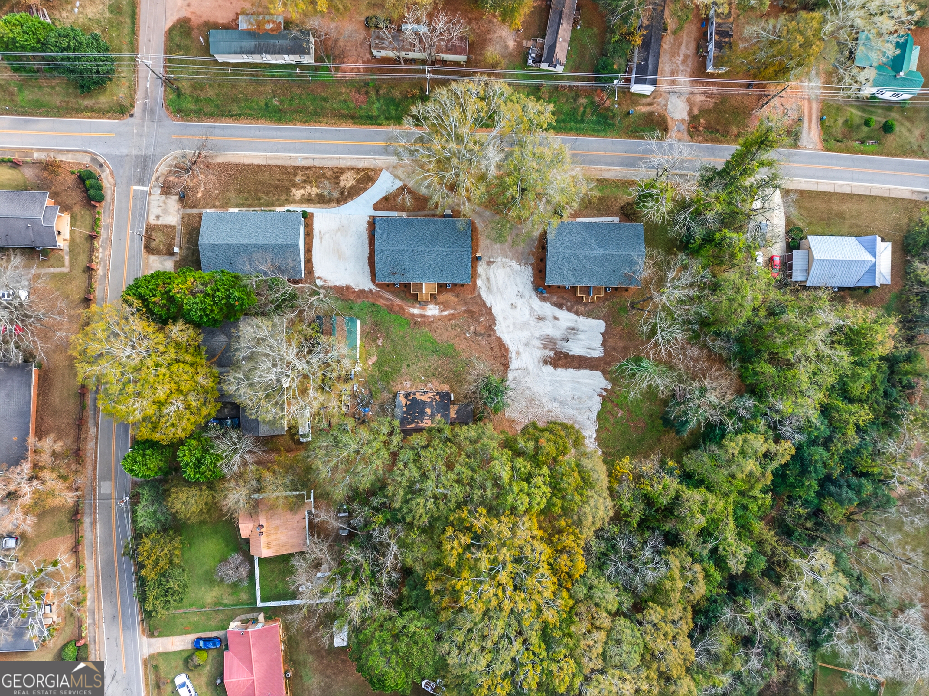 475 Vine Street, Unit B Madison, GA 30650 - Photo 18 of 23 an aerial view of a house with a yard potted plants and lake view