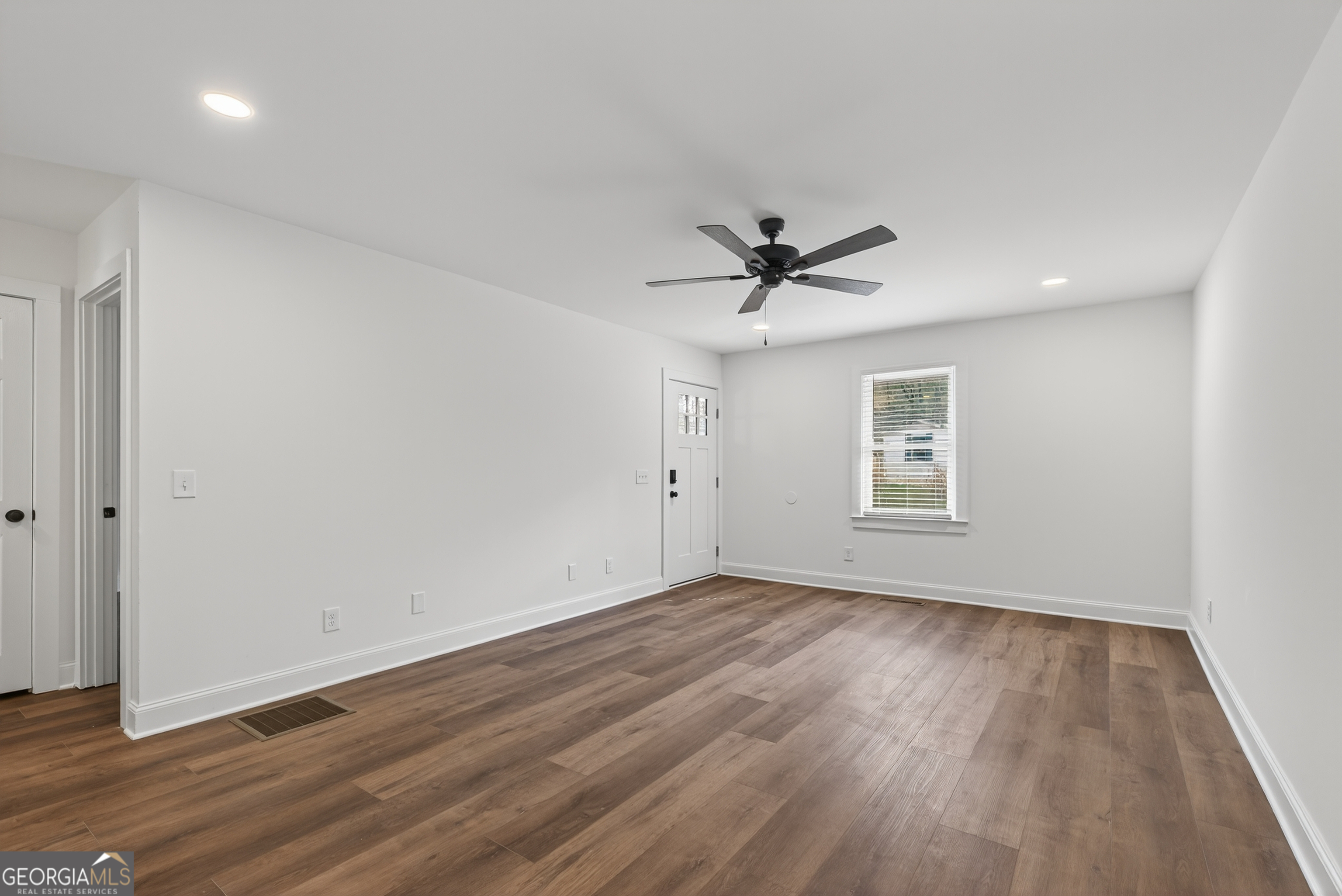 475 Vine Street, Unit B Madison, GA 30650 - Photo 7 of 23 a view of a big room with wooden floor and windows
