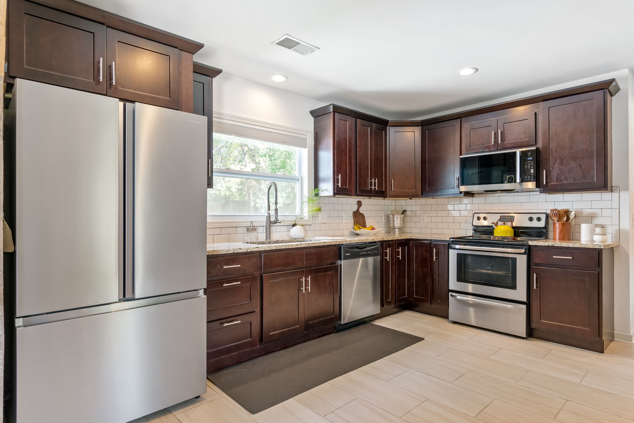 1136 Pierce Road Madison, TN 37115 - Photo 17 of 63 a kitchen with stainless steel appliances granite countertop a refrigerator stove a sink dishwasher and microwave