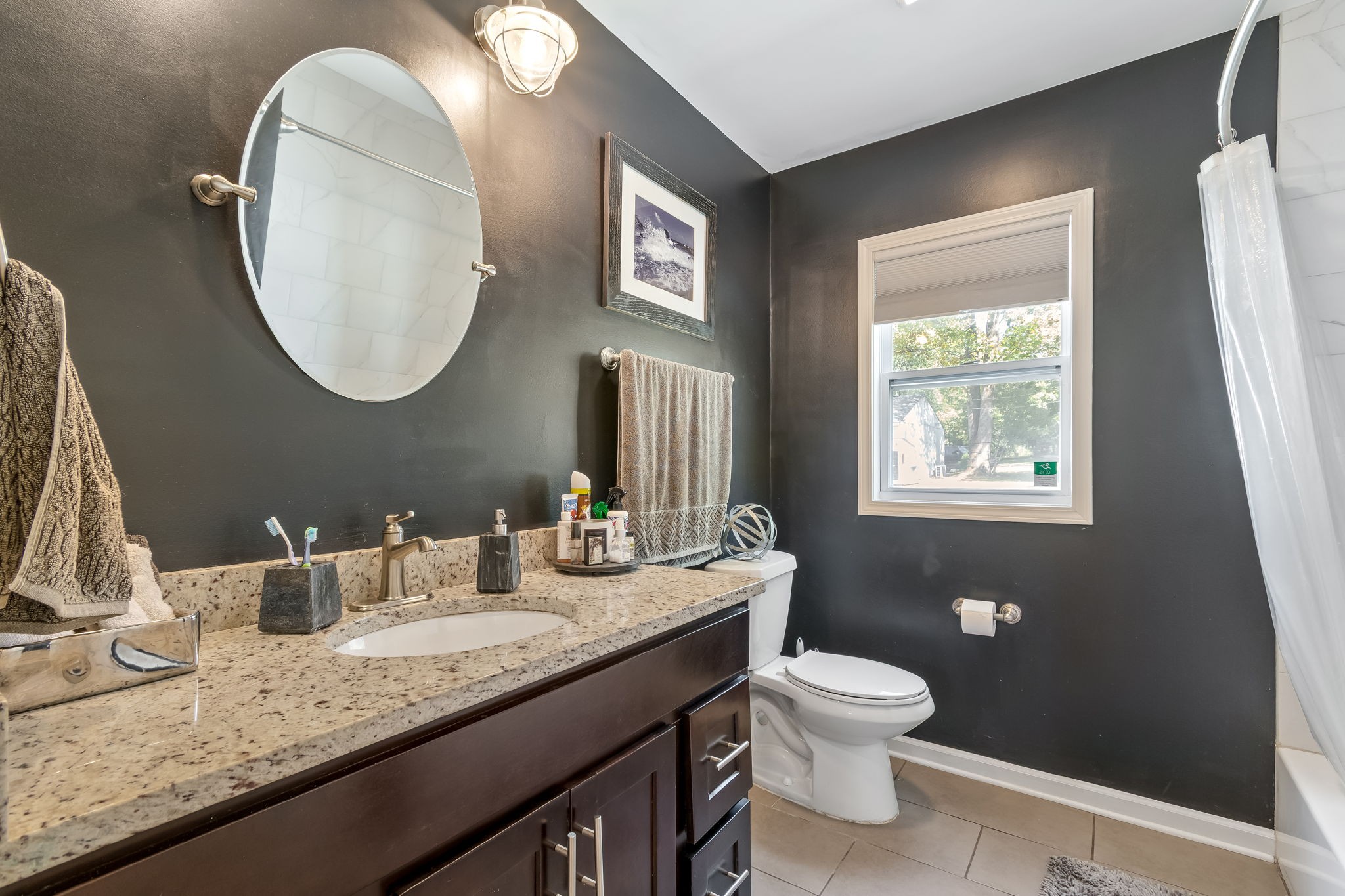 1136 Pierce Road Madison, TN 37115 - Photo 33 of 63 a bathroom with a granite countertop sink a toilet and a mirror