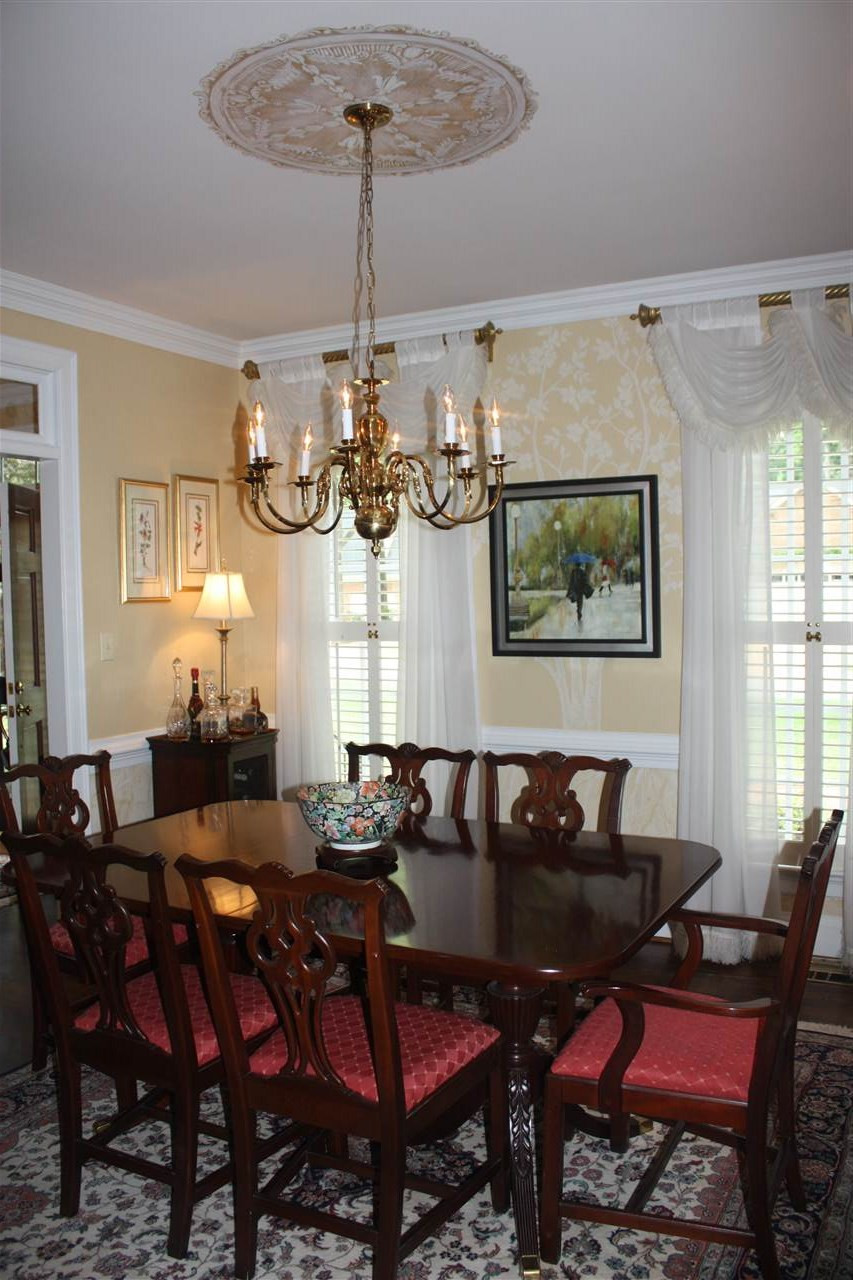 8108 Windsor Ridge Drive Raleigh, NC 27615 - Photo 23 of 25 Formal dining room with tons of details, hardwoods, and lots of natural light. Dining Room