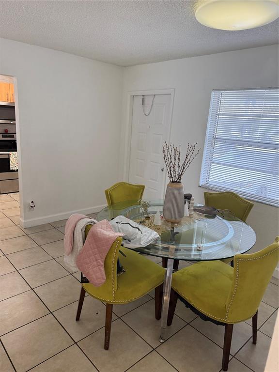 4745 Northwest 9th Drive, Unit 4745 Fort Lauderdale, FL 33317 - Photo 12 of 15 a view of a dining room with furniture