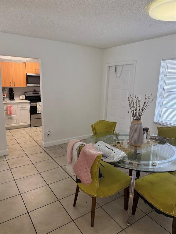 4745 Northwest 9th Drive, Unit 4745 Fort Lauderdale, FL 33317 - Photo 13 of 15 a view of a dining room with furniture