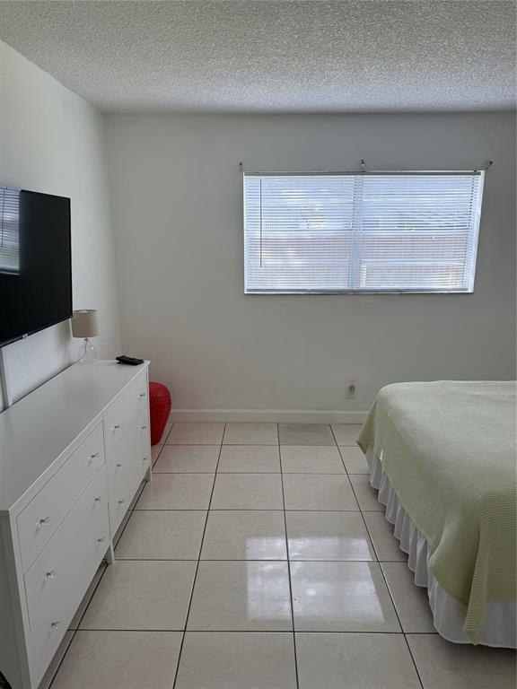 4745 Northwest 9th Drive, Unit 4745 Fort Lauderdale, FL 33317 - Photo 6 of 15 a room with a bed and a flat screen tv