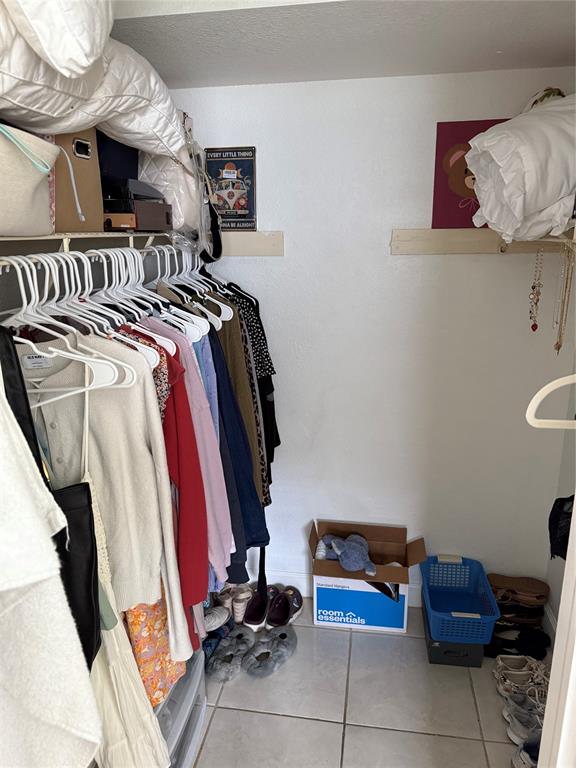 4745 Northwest 9th Drive, Unit 4745 Fort Lauderdale, FL 33317 - Photo 7 of 15 a view of walk in closet with clothes and shoes