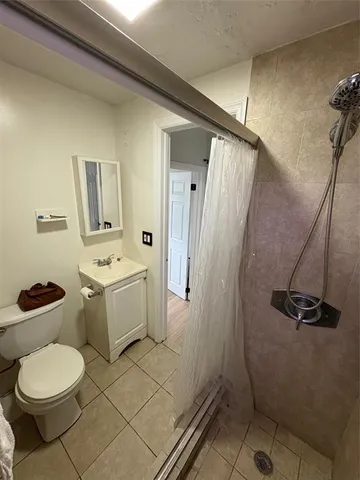 a bathroom with a toilet sink and shower