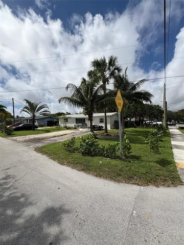 a car parked in front of a house and a yard