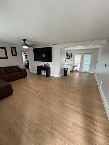 a view of a livingroom with furniture and flat screen tv