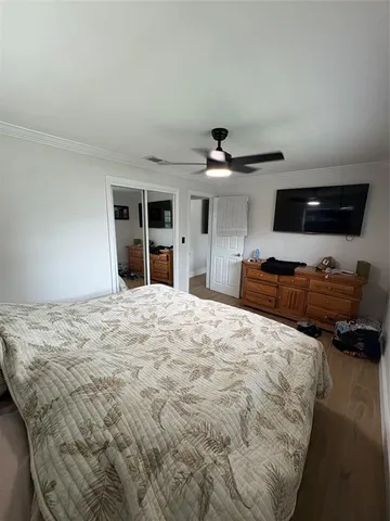 a bedroom with a bed and a large window