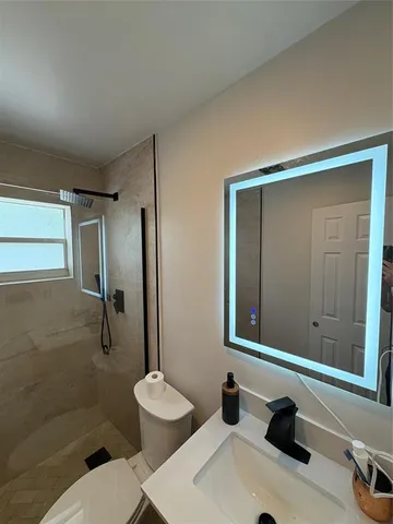 a bathroom with a sink toilet and shower