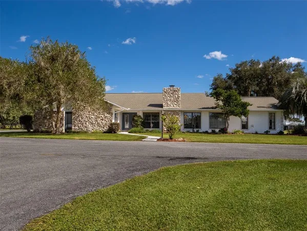 a front view of a house with a big yard