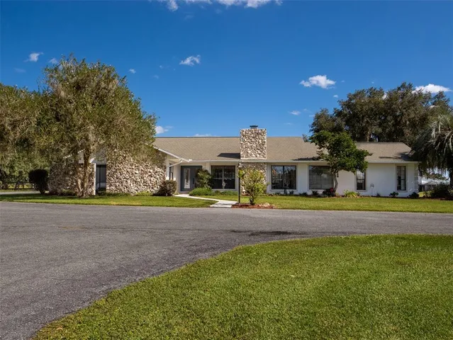 a front view of a house with a big yard