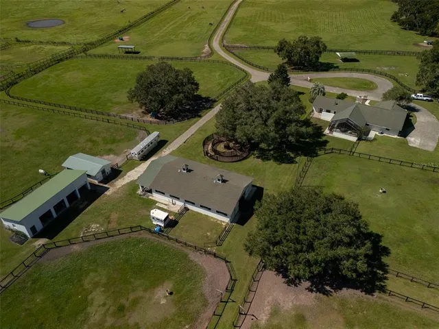 an aerial view of a house with a yard