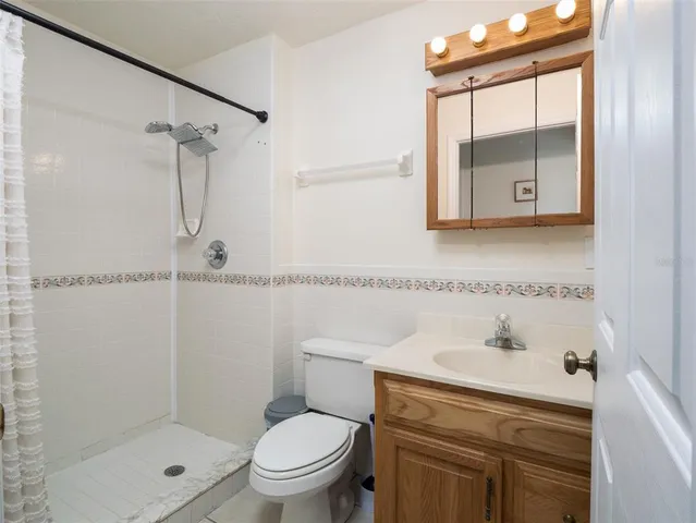 a bathroom with a sink mirror vanity and toilet