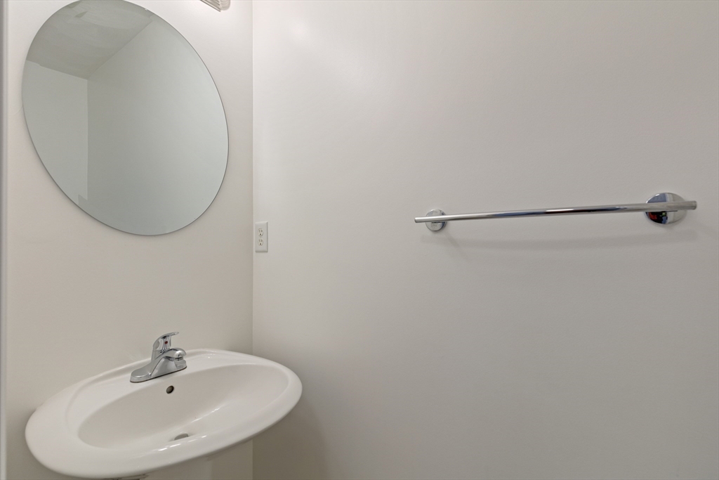 555 Main Street, Unit 10 Woburn, MA 01801 - Photo 19 of 39 a bathroom with a sink and mirror