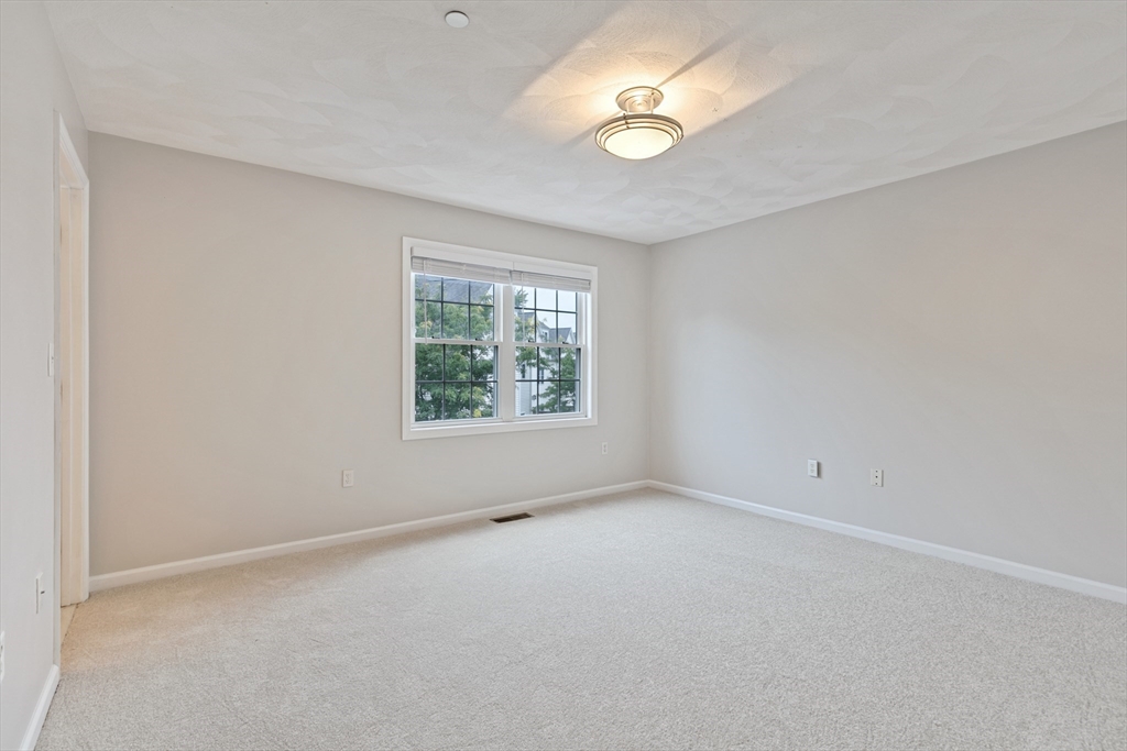 555 Main Street, Unit 10 Woburn, MA 01801 - Photo 21 of 39 an empty room with windows and fan